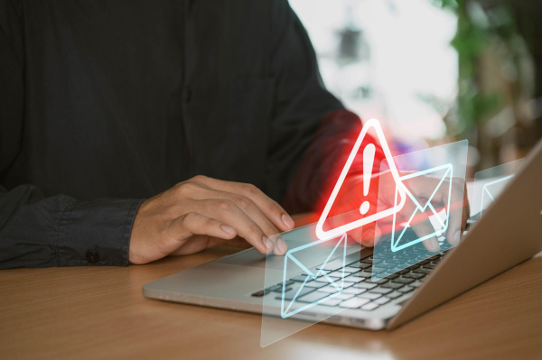 Person reviewing suspicious work from home job offer on laptop